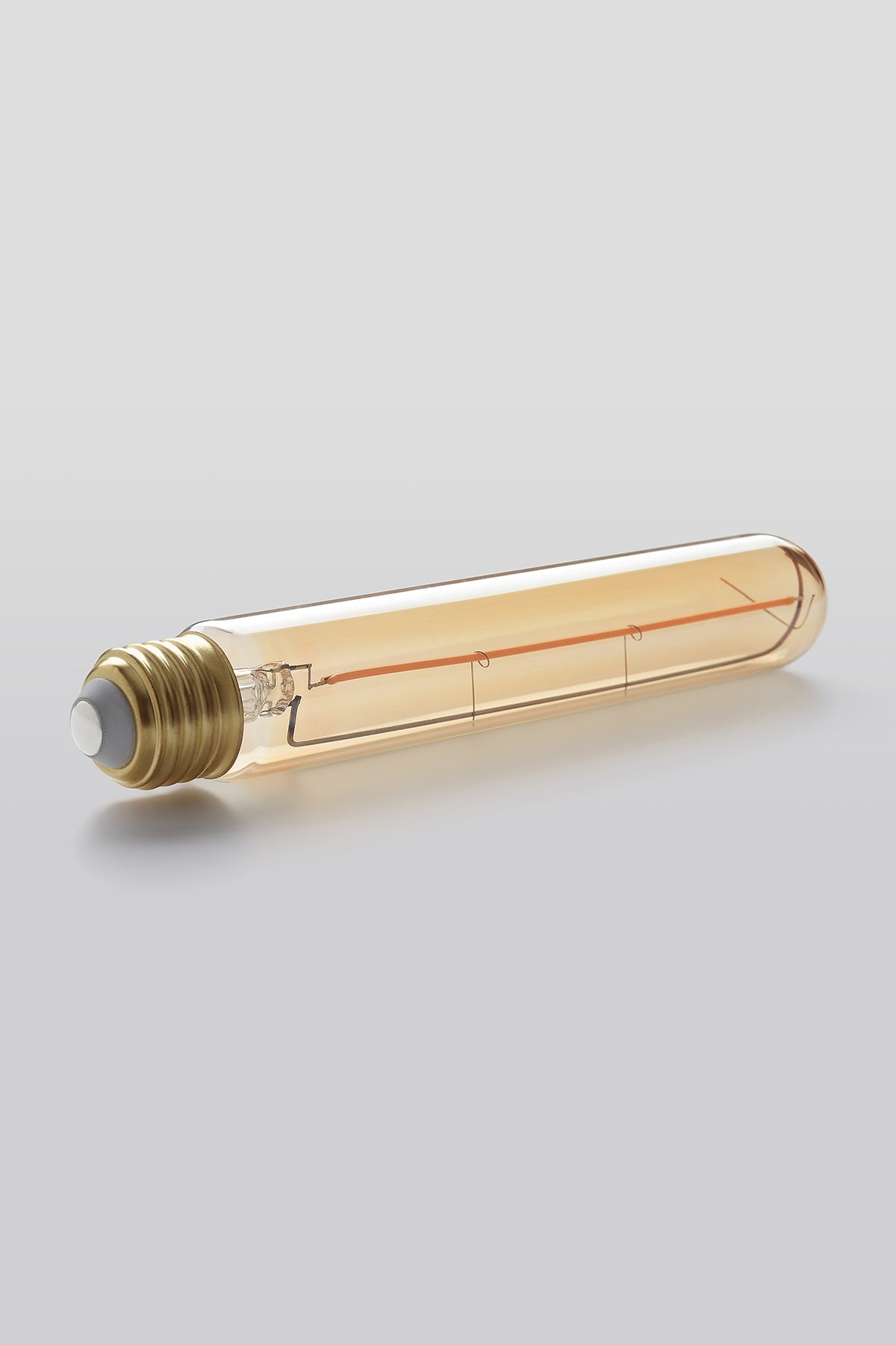 Modern T9 LED light bulb with warm vintage Edison style glow