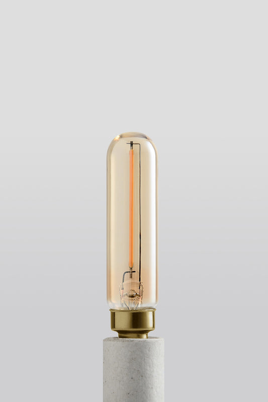 Modern T6 LED light bulb with warm vintage Edison style glow