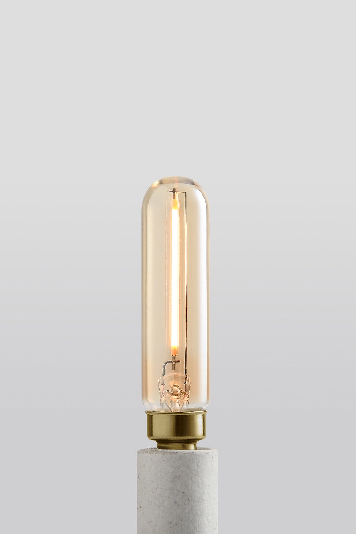 Modern T6 LED light bulb with warm vintage Edison style glow