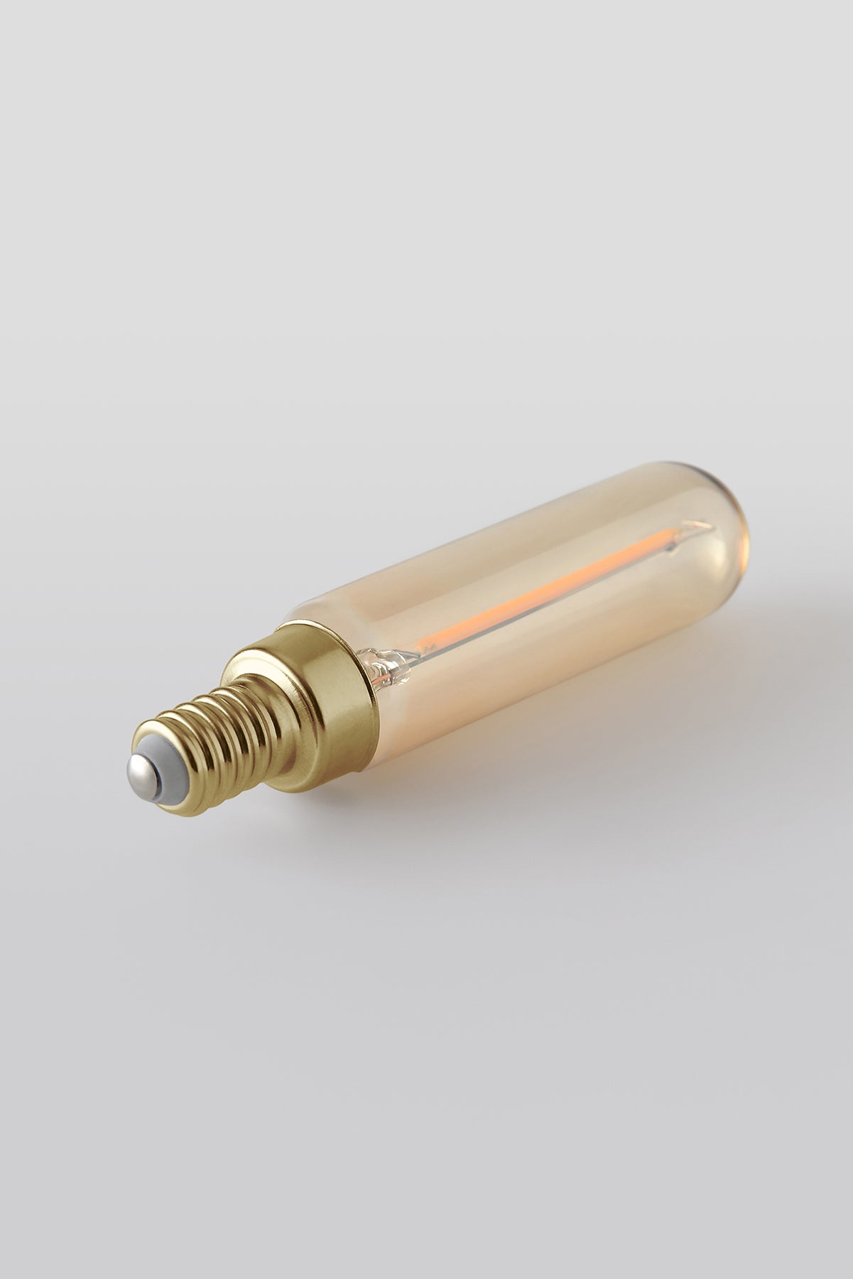 Modern T6 LED light bulb with warm vintage Edison style glow