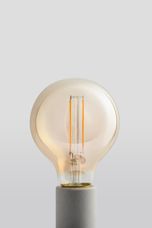 Modern G25 LED light bulb with warm vintage Edison style glow