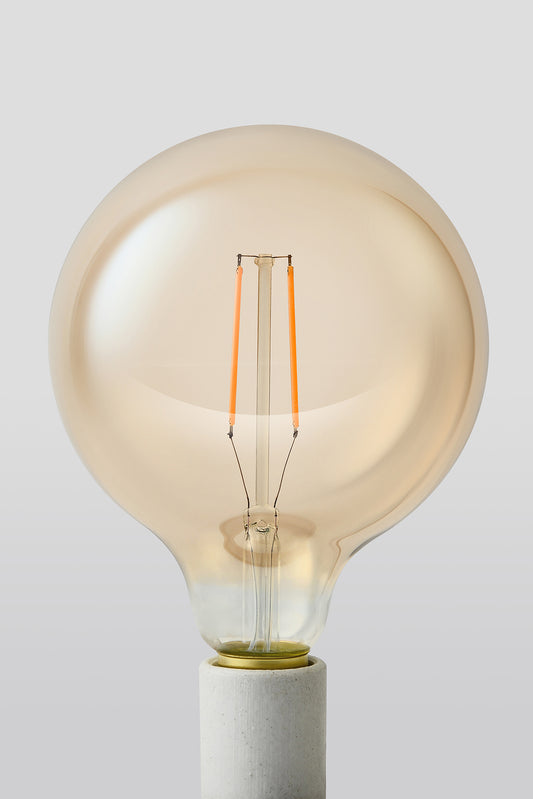 Modern G40 LED light bulb with warm vintage Edison style glow