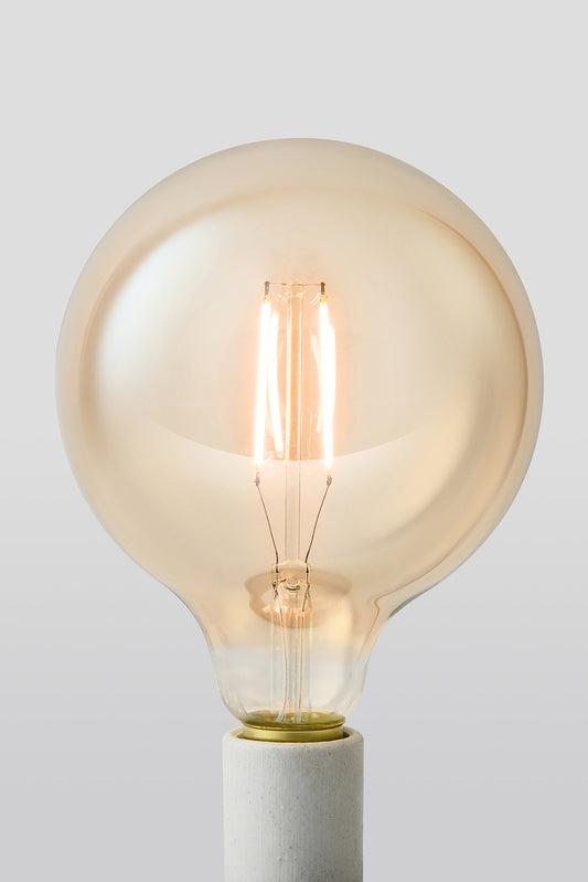 Modern G40 LED light bulb with warm vintage Edison style glow