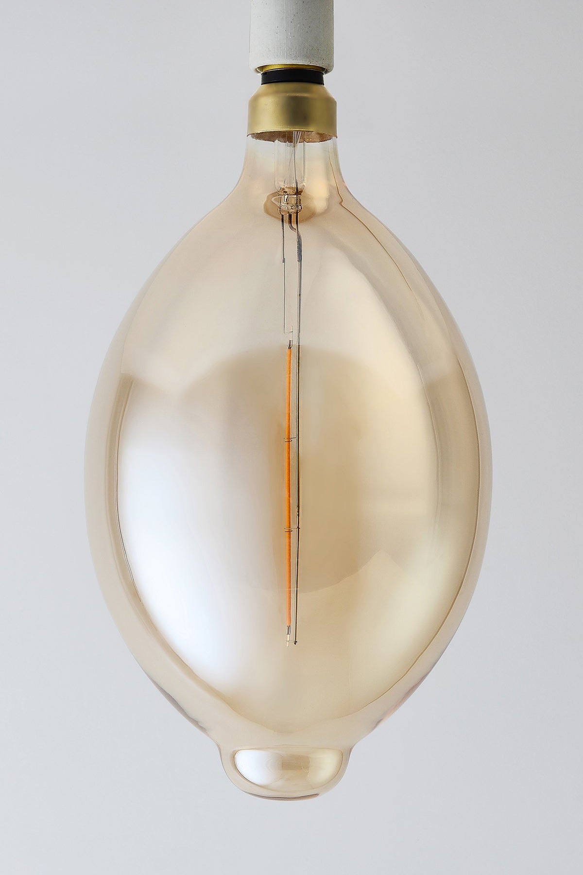 Modern oval LED light bulb with warm vintage Edison style glow