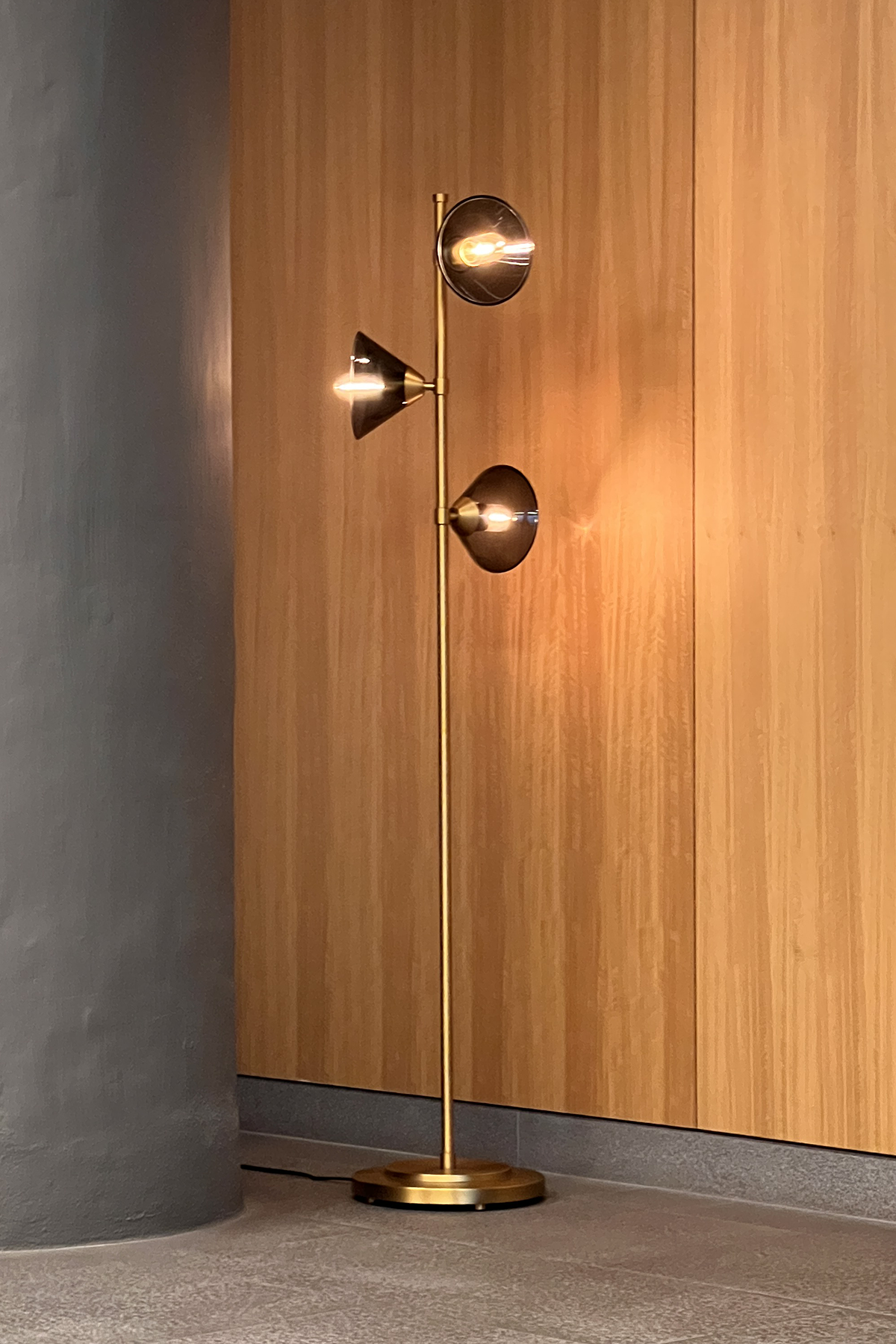 Amplitude Floor Lamp floor lamp against a wooden wall