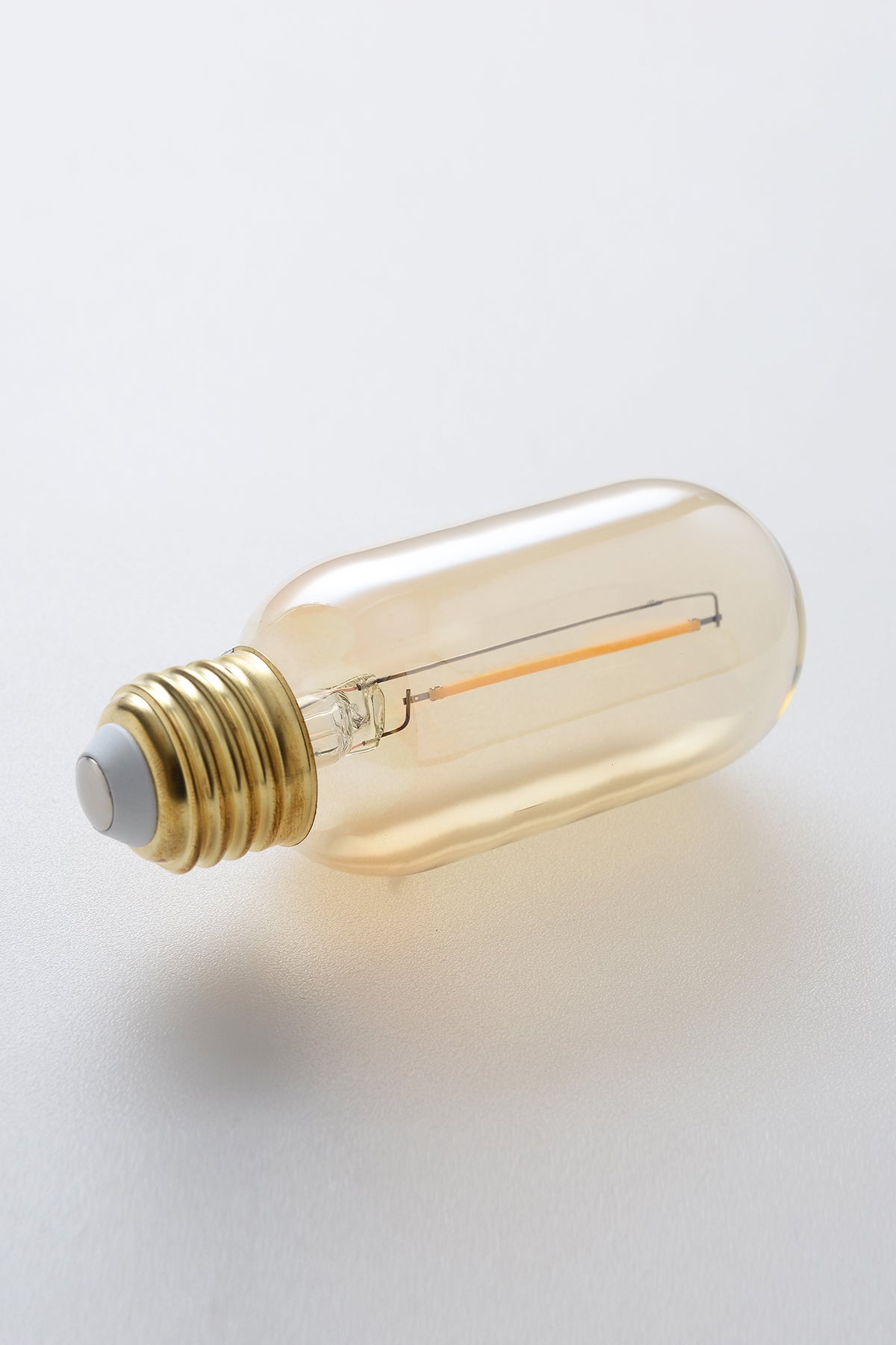 Modern T14 LED light bulb with warm vintage Edison style glow