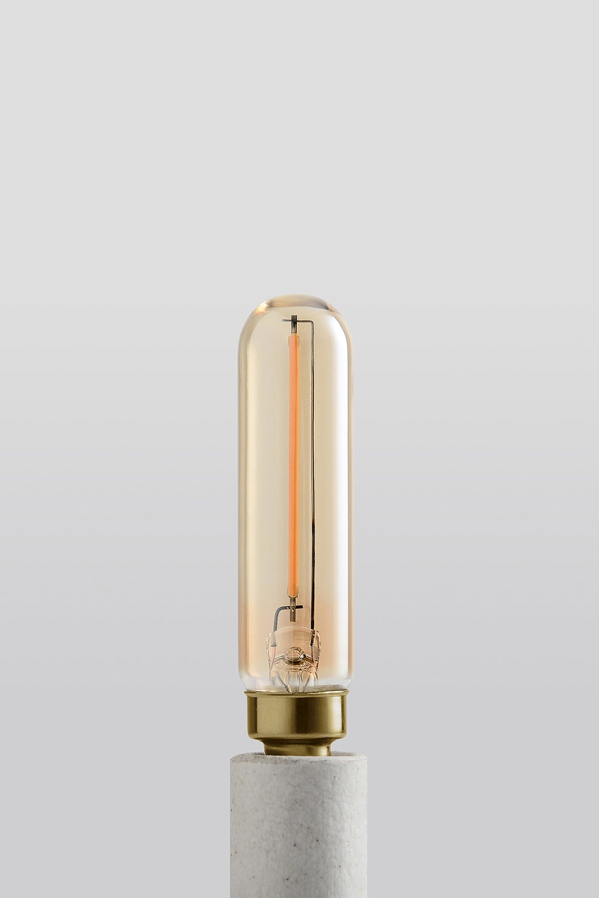 Modern T6 LED light bulb with warm vintage Edison style glow