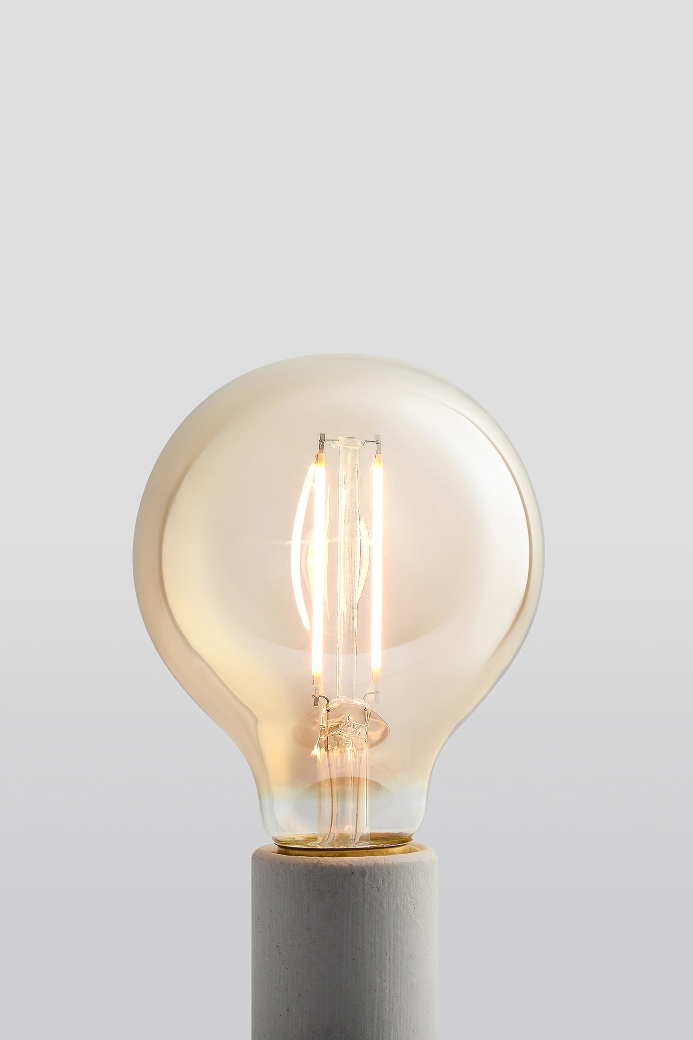 Modern G25 LED light bulb with warm vintage Edison style glow
