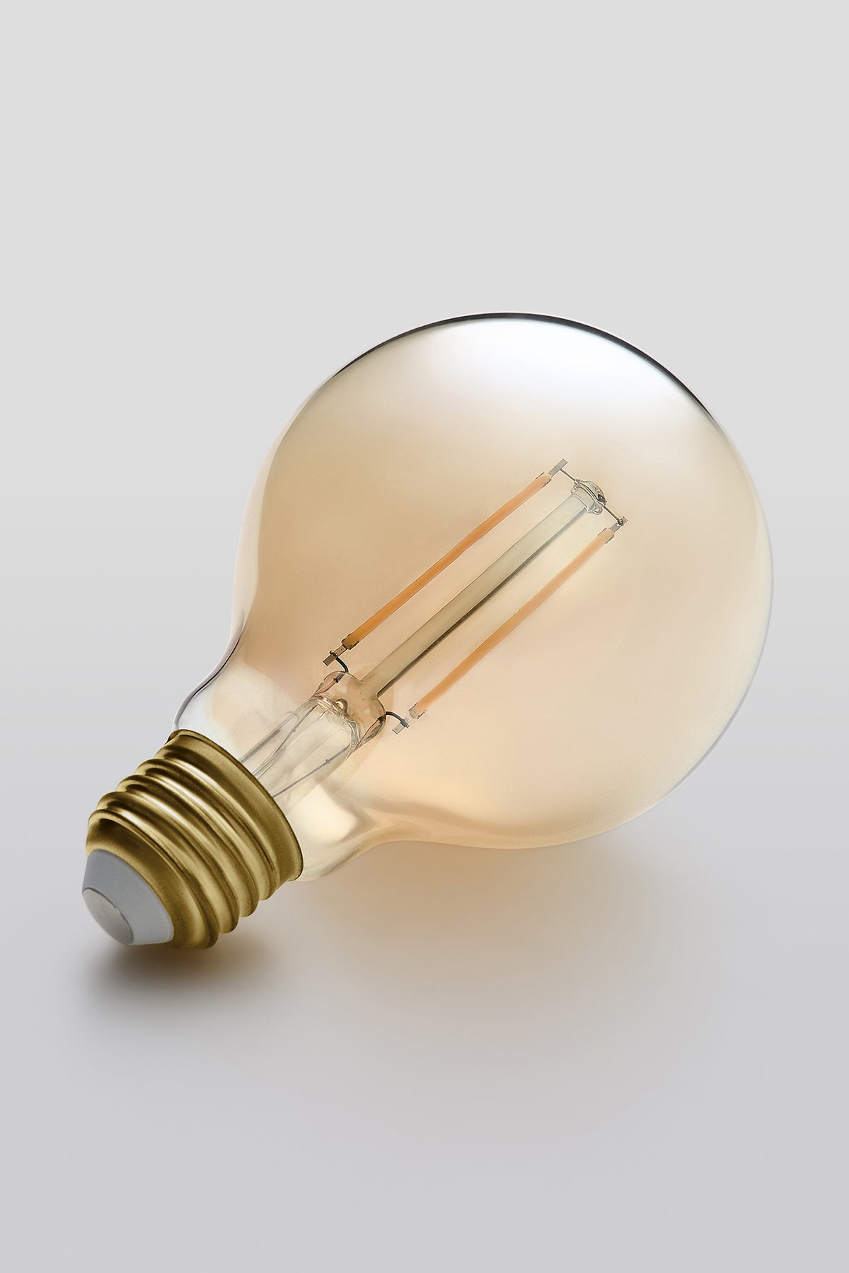 Modern G25 LED light bulb with warm vintage Edison style glow