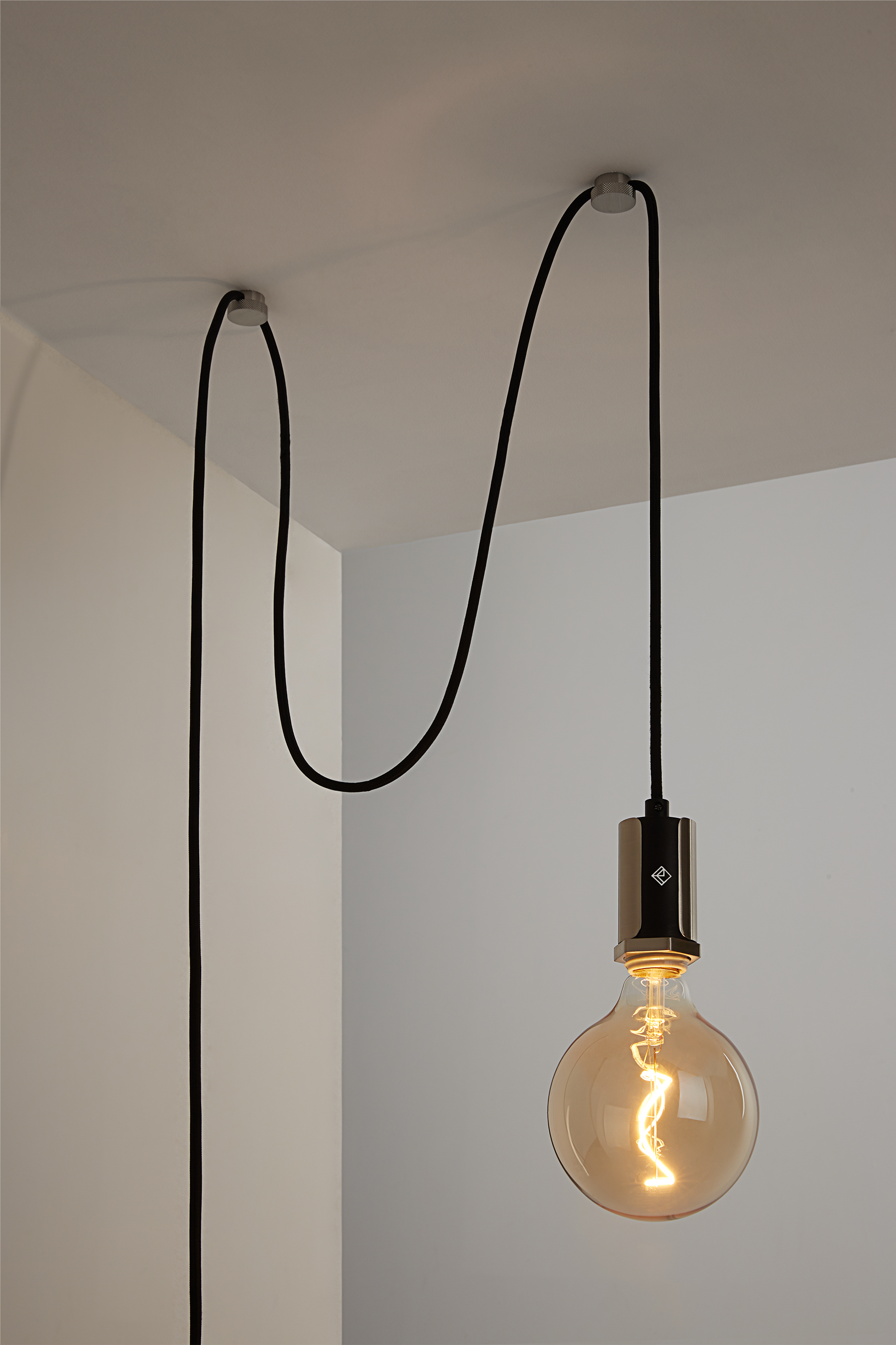The Alamere Plug-In Pendant is the ideal ceiling pendant lamp for any space. Easy to install, it plugs into any standard wall outlet and comes with two cord anchors to hang it anywhere. An inline dimmer on the cord allows for adjustability with any compatible dimming light bulb.