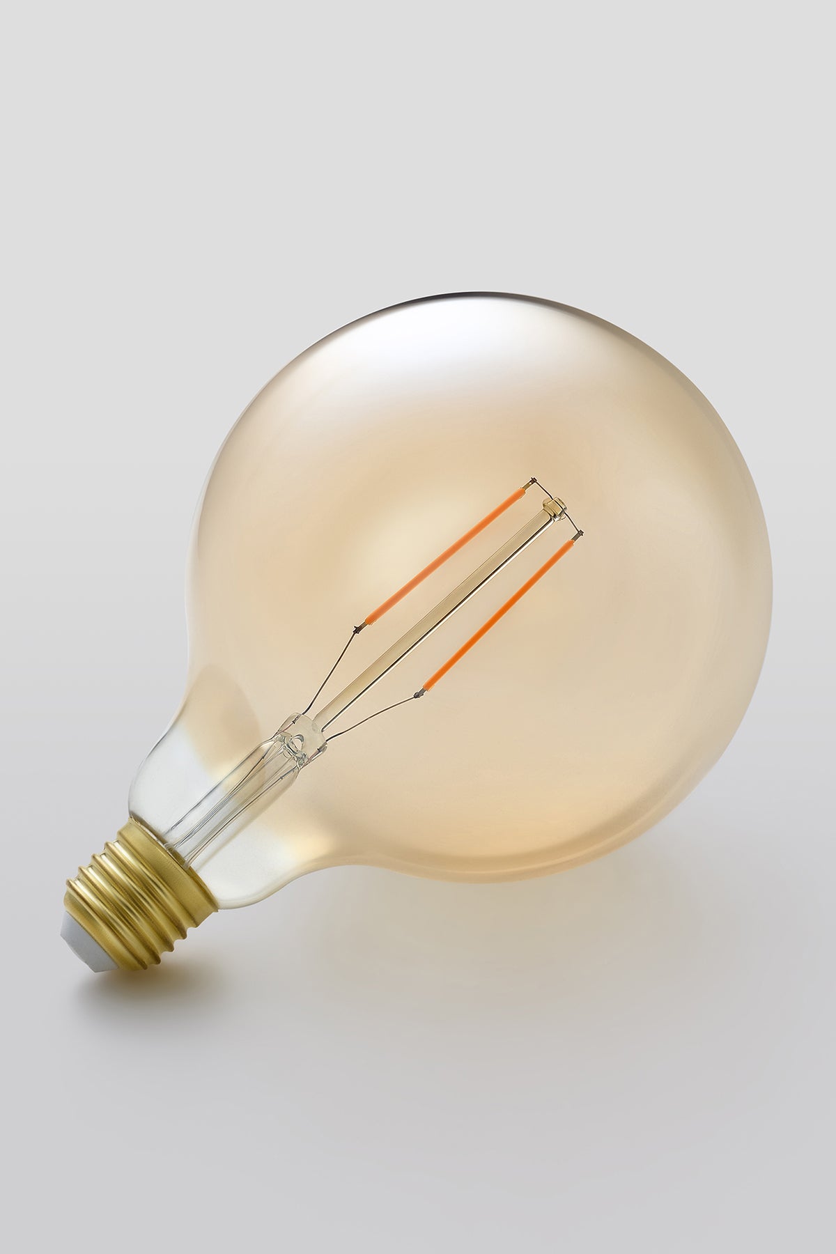 Modern G40 LED light bulb with warm vintage Edison style glow
