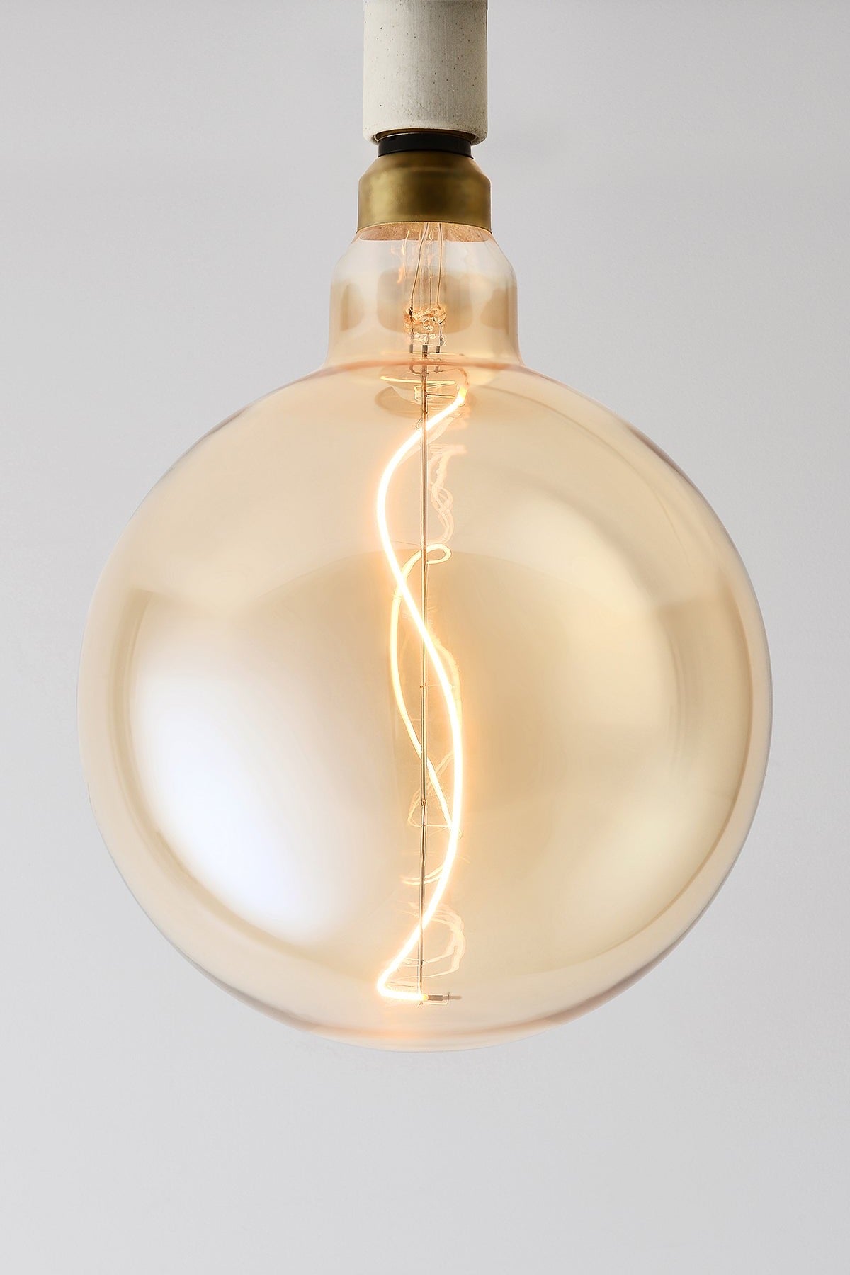 Modern globe LED light bulb with warm vintage Edison style glow
