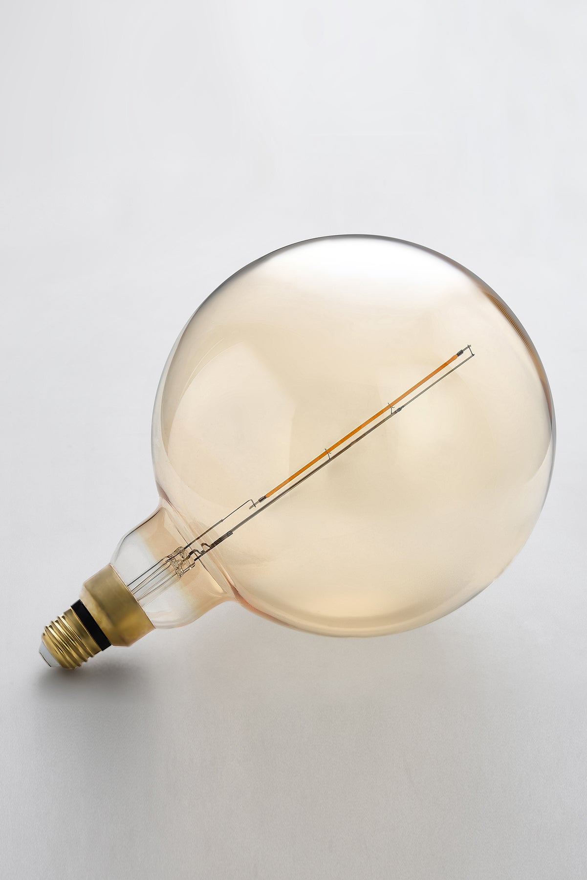 Modern globe LED light bulb with warm vintage Edison style glow