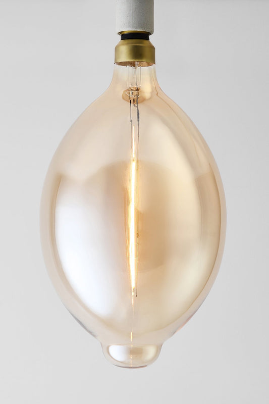 Modern oval LED light bulb with warm vintage Edison style glow
