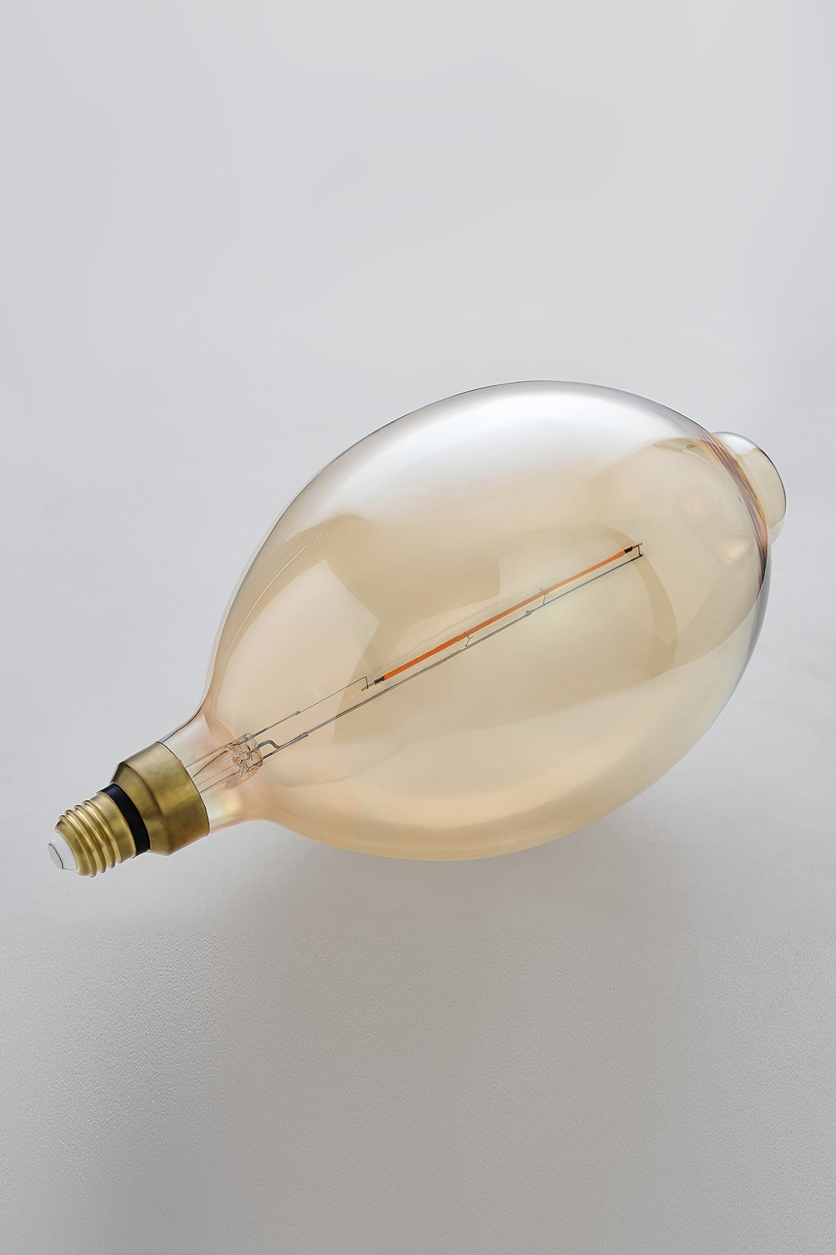 Modern oval LED light bulb with warm vintage Edison style glow